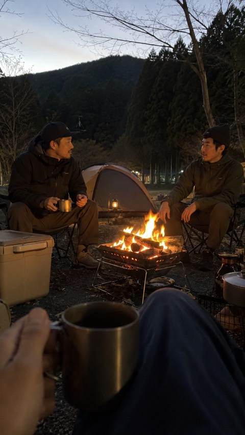 Dusk, around a campfire