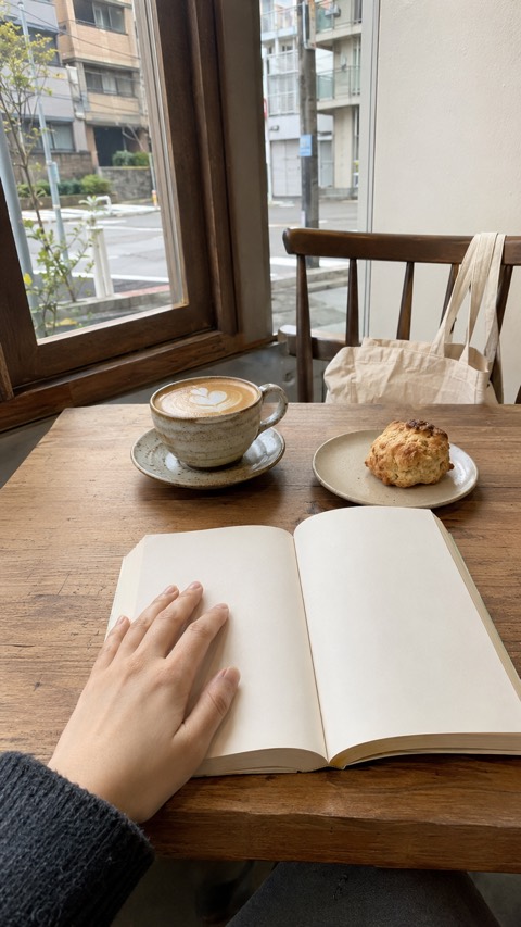 Noon, an open notebook at a café window